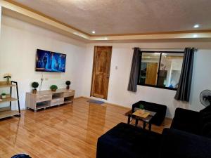 a living room with a couch and a table at 3 Bedrooms 2 storey House in Dipolog