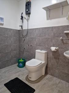a bathroom with a toilet and a shower at 3 Bedrooms 2 storey House in Dipolog +15 photos