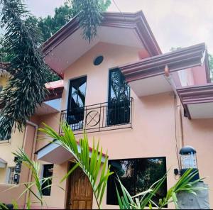 a house with a balcony and plants in front of it at 3 Bedrooms 2 storey House in Dipolog