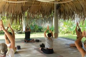 a group of people doing yoga under a hut at Lotus Surf And Wellness in Ahangama +36 photos