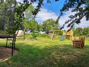 a park with a playground in the grass at Naturhof-Goldbeck in Klütz