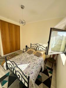 a bedroom with a bed and a large window at Atlantic Foz in Buarcos +9 photos