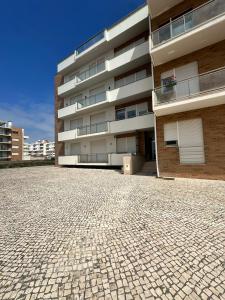 a building with a cobblestone street in front of it at Atlantic Foz in Buarcos