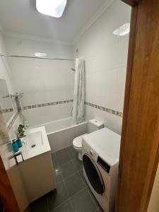 a small bathroom with a toilet and a sink at Atlantic Foz in Buarcos