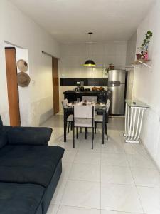 a living room with a table and a kitchen at Casa do sossego in Juazeiro do Norte +17 photos
