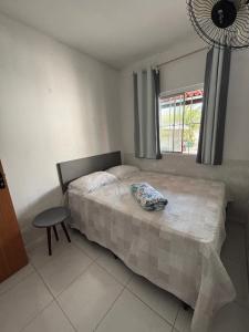 a bedroom with a bed and a chair and a window at Casa do sossego in Juazeiro do Norte +17 photos