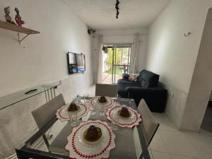 a living room with a glass table with cakes on it at Casa do sossego in Juazeiro do Norte