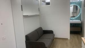 a living room with a couch and a mirror at Lara Elite in Castiglione della Pescaia