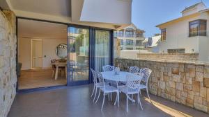 a patio with a table and chairs on a balcony at Le Paradis 5 in Hermanus