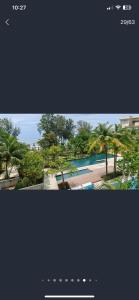 a collage of two pictures of a swimming pool at By The Sea in Batu Ferringhi +8 photos