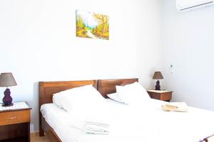 two twin beds in a room with two lamps at Sylvia Studios in Kalymnos