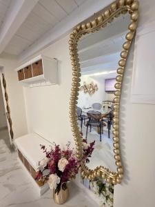 a mirror in a dining room with a table at Barbarian in Rhodes Town
