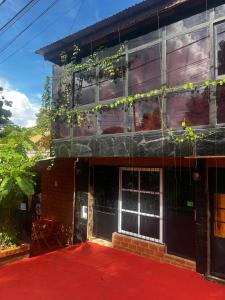 a building with a red carpet in front of it at Guazú Departamentos in Puerto Iguazú