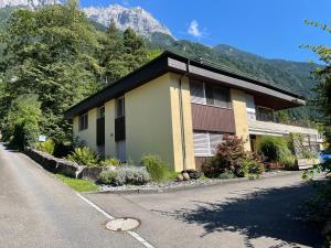 a house on the side of a road with a mountain at Ferienwohnung Efibach 41 in Silenen