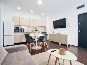 a living room with a table and a kitchen at Esther Line Apartments-Near Iulius Mall, Self Check-in,Free Private Parking subject to availability in Timişoara