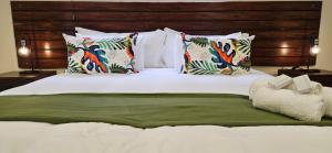 a large bed with many pillows at Shiloah Guesthouse Unit 4 in Oranjemund