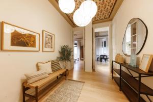 a living room with a couch and a mirror at Bravissimo Plaça del Vi, Authentic Historic Apartment in Girona