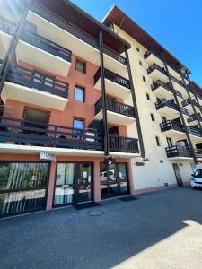 an apartment building with balconies and a parking lot at Studio puy saint Vincent in Puy-Saint-Vincent