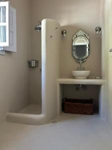 a bathroom with a sink and a mirror at Villa Iza in Skala +10 photos