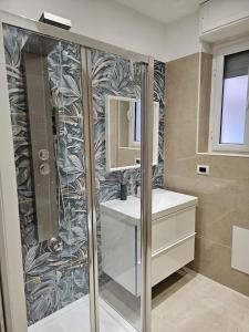 a bathroom with a shower and a sink and a mirror at GM Family in Siderno Marina +20 photos