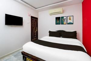 Ένα ή περισσότερα κρεβάτια σε δωμάτιο στο Hotel O Lavish Stay Inn