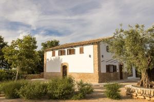 a white house with a tree in front of it at Mas d'en Jan in Roquetas