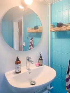 a bathroom with a sink and a mirror at Cooking Over Fire And Coziness Near Ajstrup Beach in Ajstrup Strand