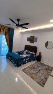 a bedroom with a bed and a ceiling fan at Teratak Kencana Impian Islamic Only in Sungai Lalang
