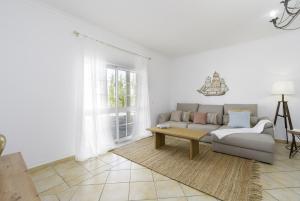 a living room with a couch and a table at Villa Menina by Ocvillas in Albufeira +34 photos