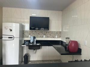 a kitchen with a sink and a refrigerator at Casa Alto da Sereia in Salvador