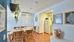 a dining room with a table and a refrigerator at Nomad Haux in the heart of Tossa 6 in Tossa de Mar +22 photos
