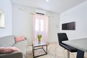 a living room with a couch and a table at Apartments Elettra in Umag