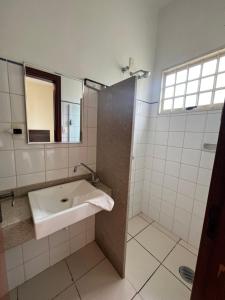 a bathroom with a sink and a mirror at Hotel e Restaurante Chão Nativo in São José da Barra +24 photos