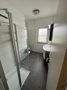 a bathroom with a shower and a sink at Leuchtturmblick in Borkum