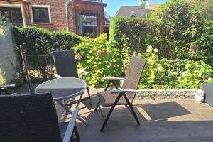 a group of chairs and a table on a patio at Kleiner Zander in Borkum