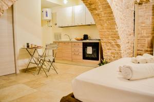 a kitchen and a bedroom with a bed and a table at B&B La Casetta di Selly in Ruvo di Puglia