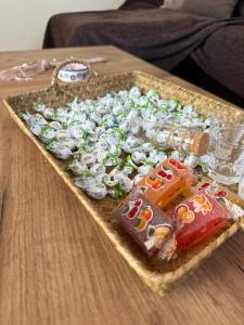 a tray full of candy on a wooden table at Loft Azure-Karfas in Chios