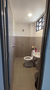 a bathroom with a toilet and a sink at Teratak Kencana Impian Islamic Only in Sungai Lalang +9 photos