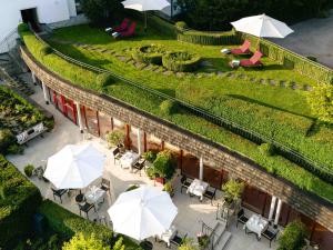 an overhead view of a patio with tables and umbrellas at Hotel Kaiserhof Kitzbühel, 4 Sterne Superior in Kitzbühel