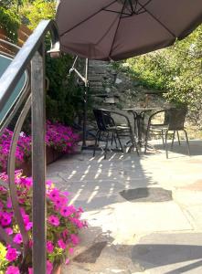a patio with a table and chairs and an umbrella at Apartament Rosalia in Srebrna Góra
