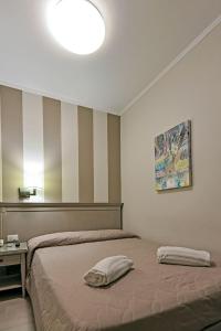 a bedroom with a bed with a pillow on it at Hotel Bristol in Trieste