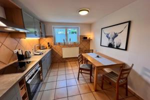 a kitchen with a table and chairs in a room at Baalmann Nr.1 in Borkum
