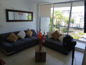 a living room with a couch and a table at Apartamento Melgar - Altagracia in Melgar