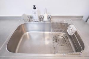 a kitchen sink with a drying rack in it at Akiba and Shinjuku - Disney - 6PPL - Private House - 15min from Mizue station in Tokyo +28 photos