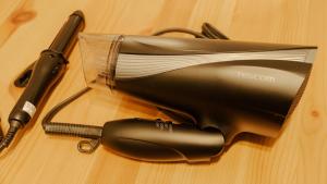 a hair dryer and a pen on a wooden table at Akiba and Shinjuku - Disney - 6PPL - Private House - 15min from Mizue station in Tokyo