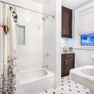 a white bathroom with a tub and a sink at Artel luxury Suits in Al Qirrān