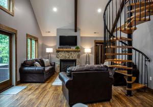 a living room with a spiral staircase in a house at Sunset Views & Mountain Getaway, 4 Min to Downtown in Mentone