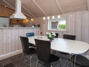a dining room with a white table and chairs at 4 star holiday home in Hemmet in Hemmet