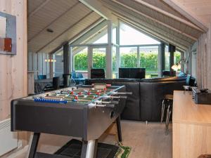 a living room with a foosball table in the middle at 4 star holiday home in Hemmet in Hemmet