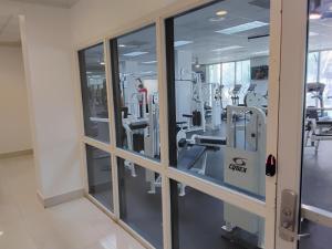 a gym with glass windows and machines at Ocean reserve 2 bedroom plus den in Sunny Isles Beach